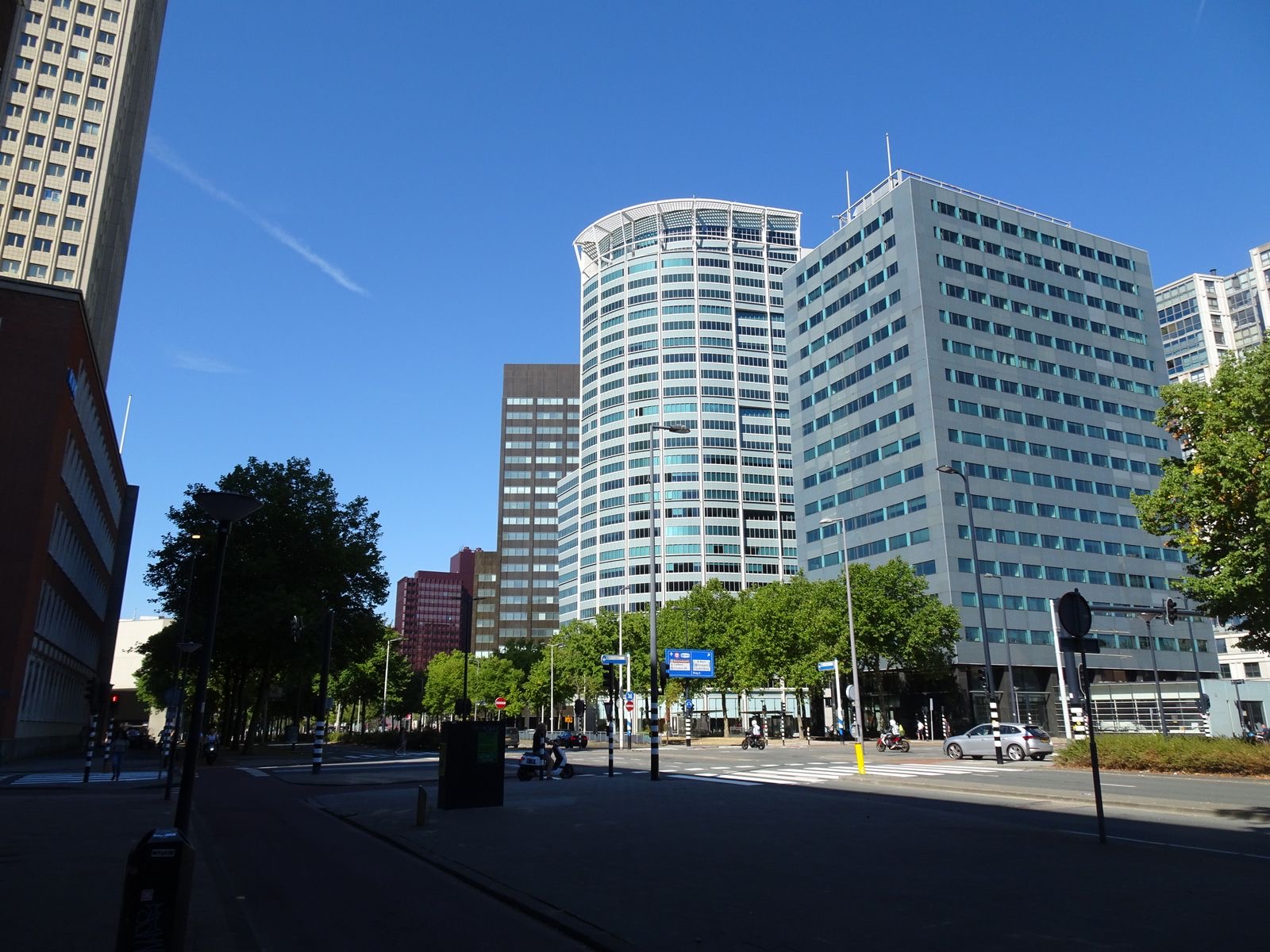 Modern office buildings along a street in central Rotterdam.