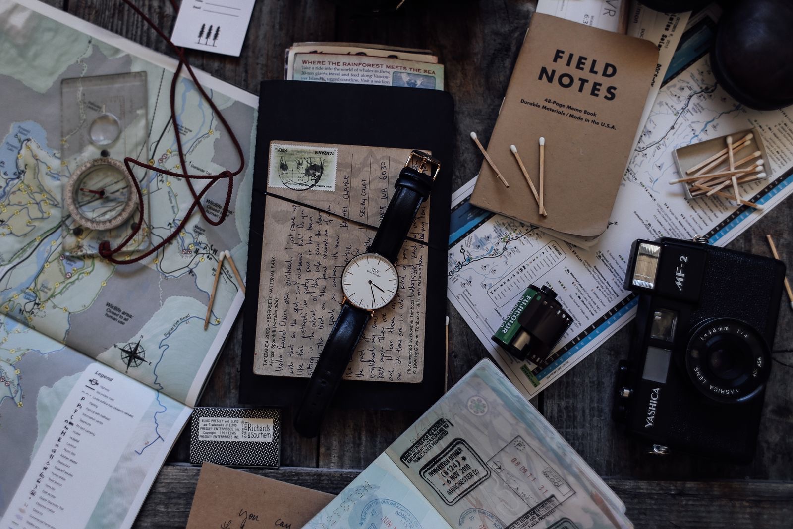 A closed passport beside certified copies of identity documents on a desk