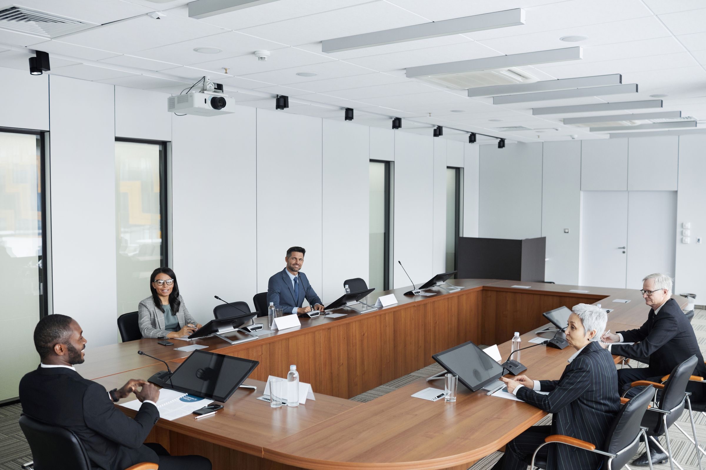 Representatives of two group companies reviewing an ownership chart at a meeting table