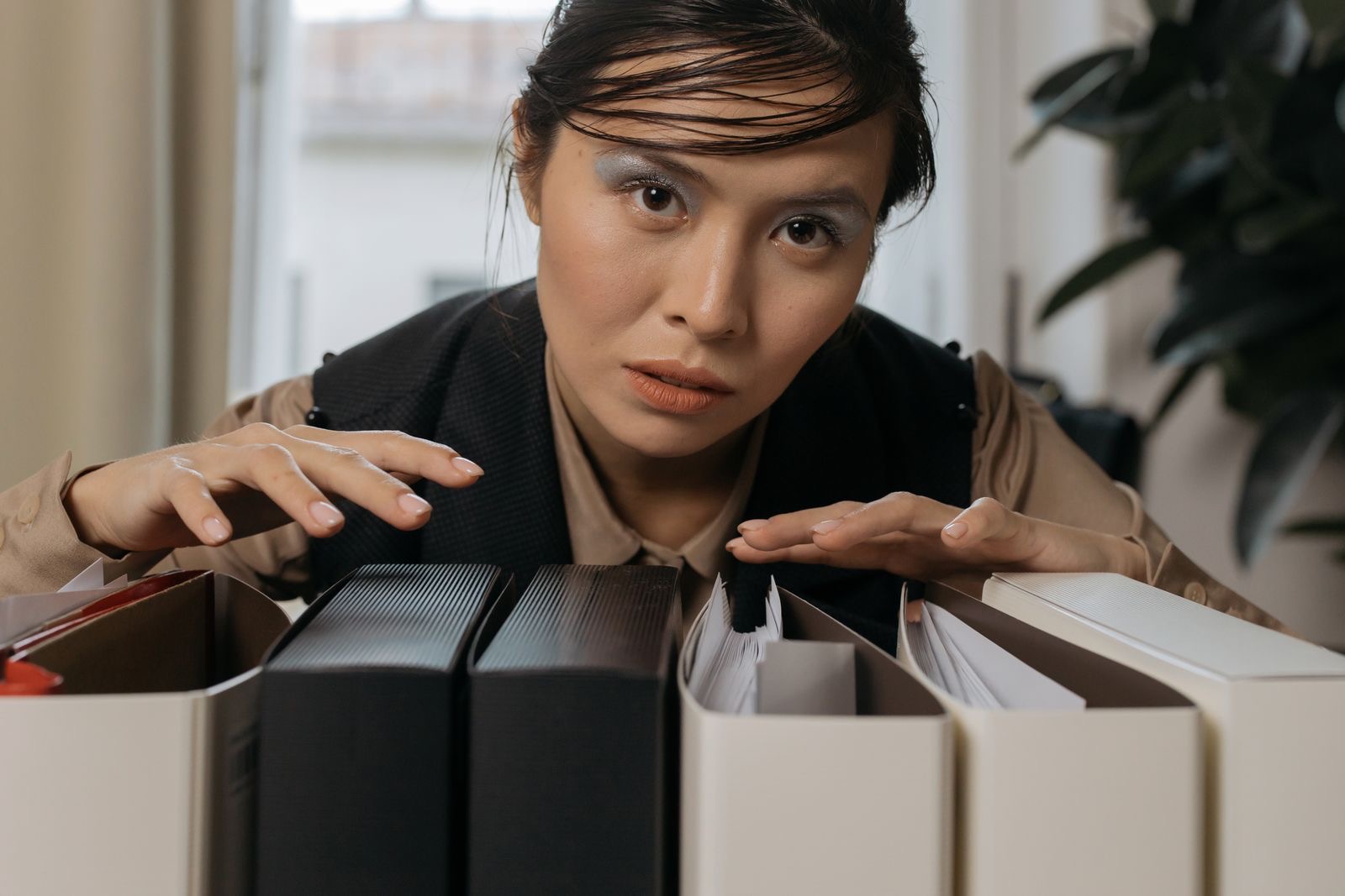 Folders of company documents and a shareholders' register assembled on a desk for a notary