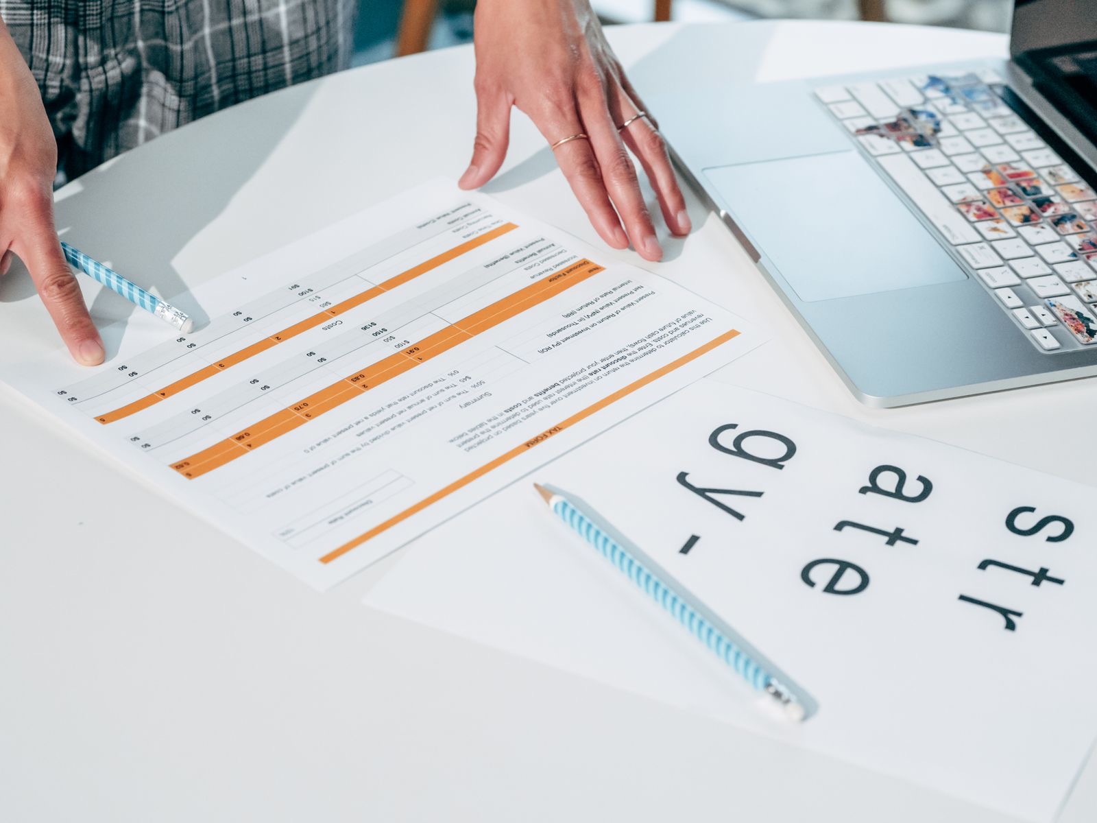 Two people at a table reviewing a printed group structure chart with intra-group arrows